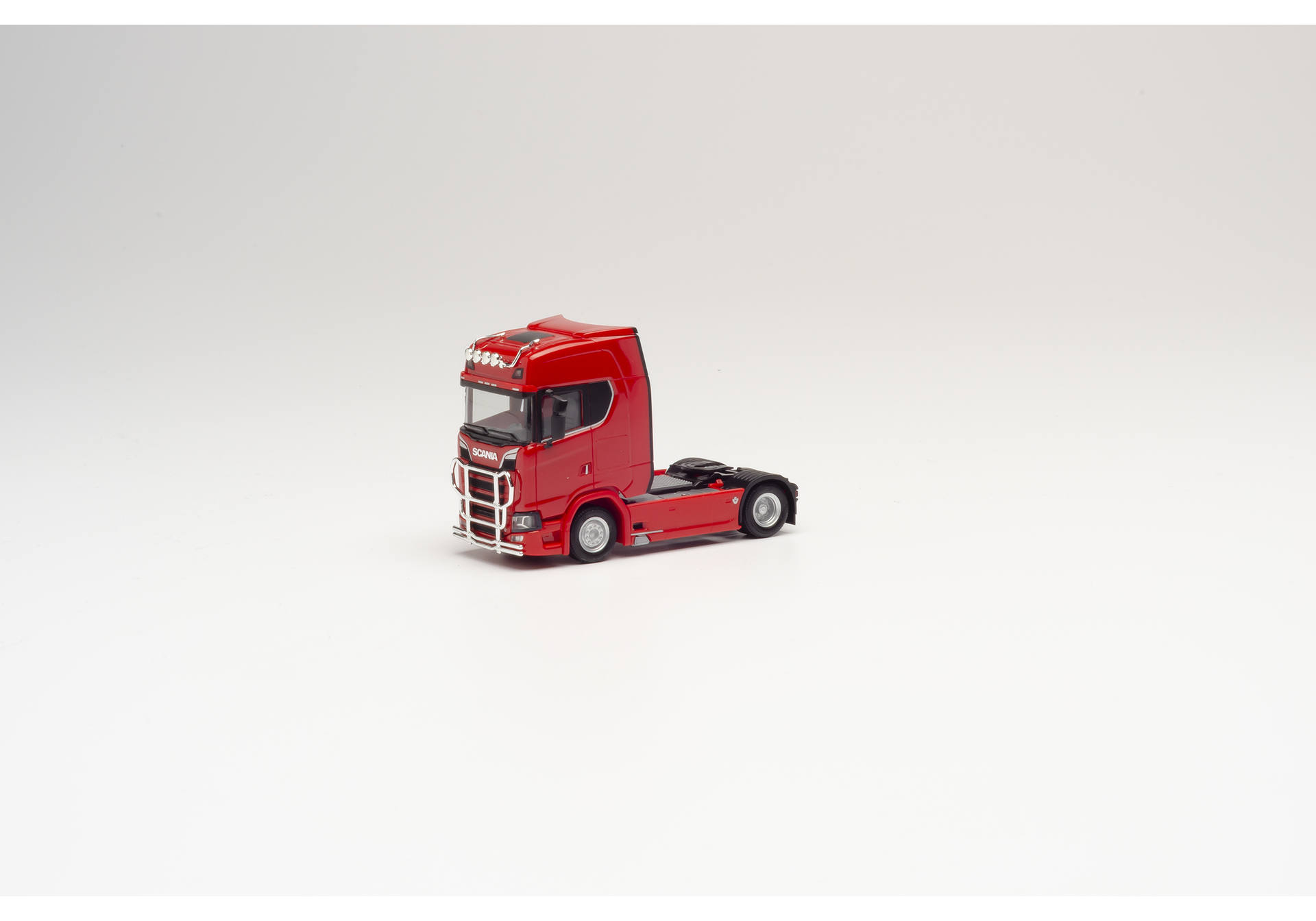 rigid tractor with impact protection and lamp bracket