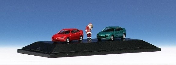 Mazda 2 323 f with Santa Claus on the base