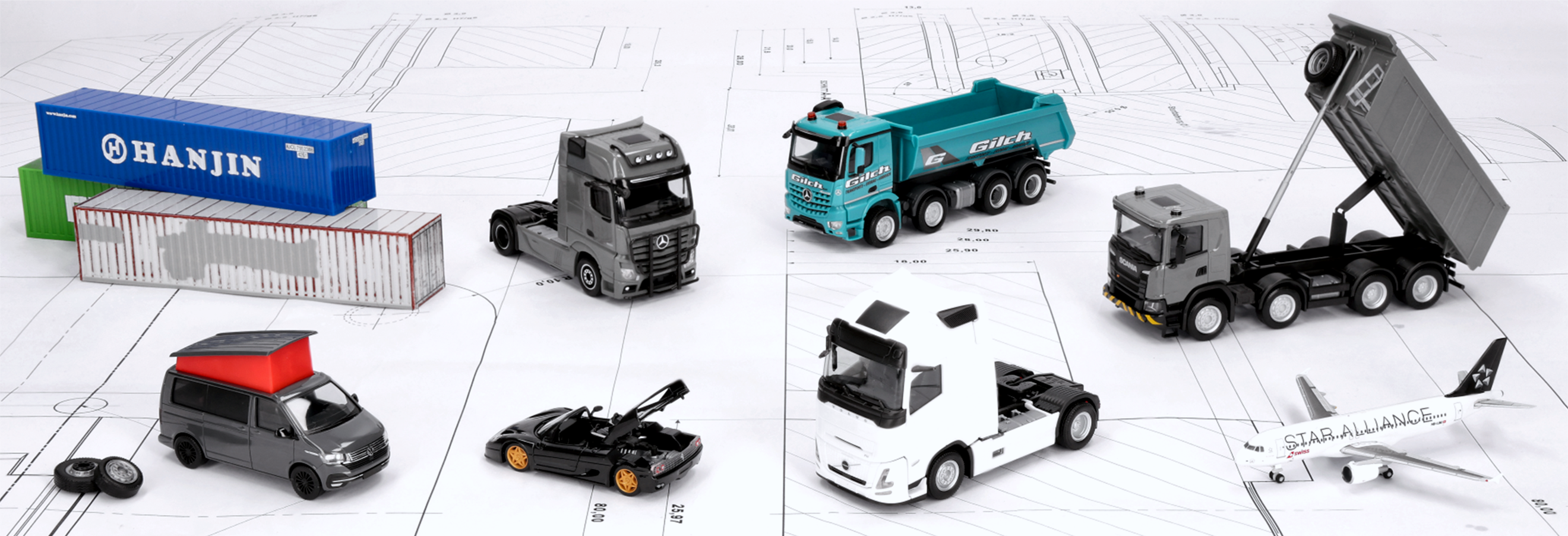 Selection from the Herpa September 2026 delivery: Miniature models are standing on a construction drawing.