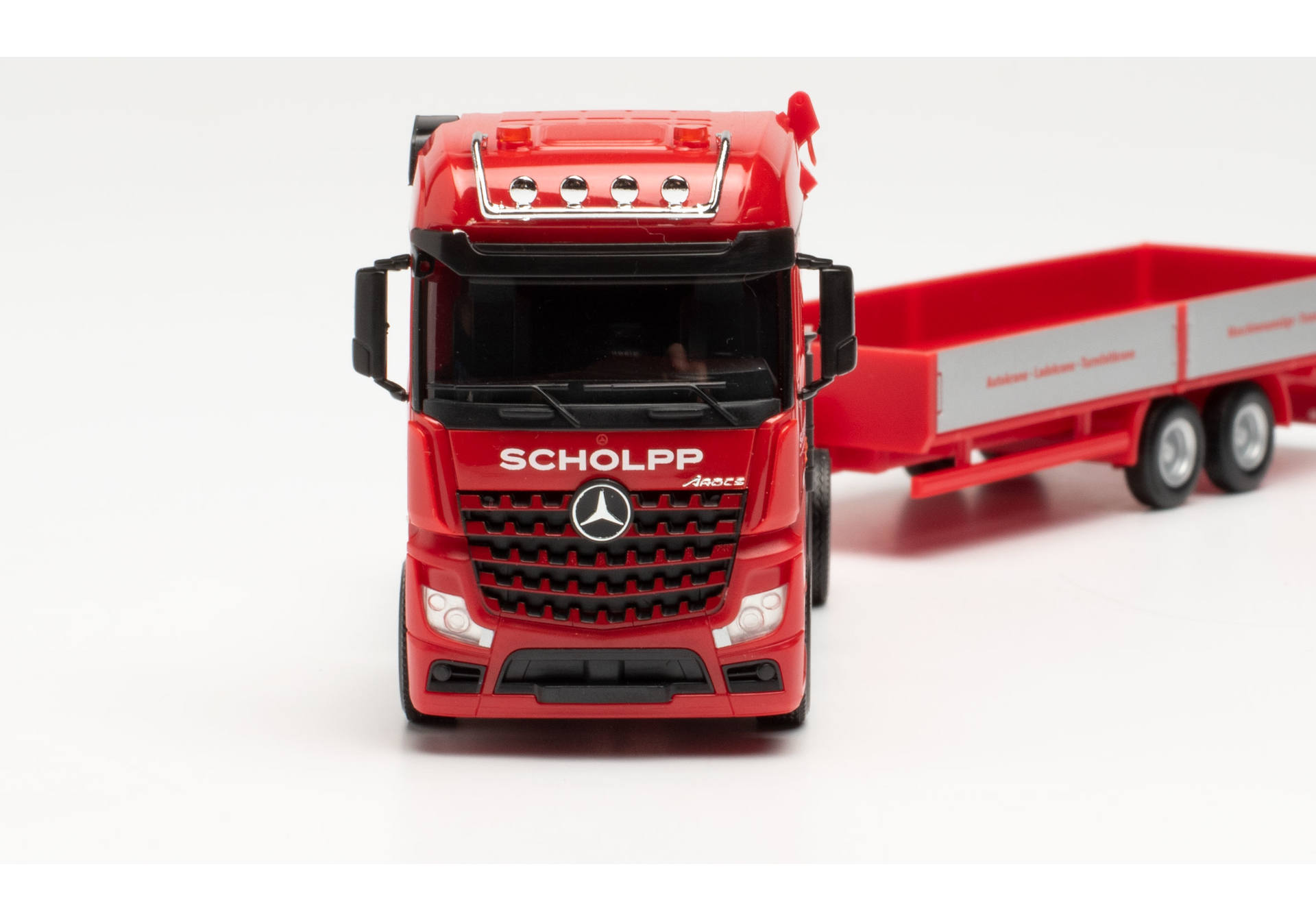 Mercedes-Benz Arocs tractor with loading crane, ballast flatbed, and low-body trailer Scholpp.