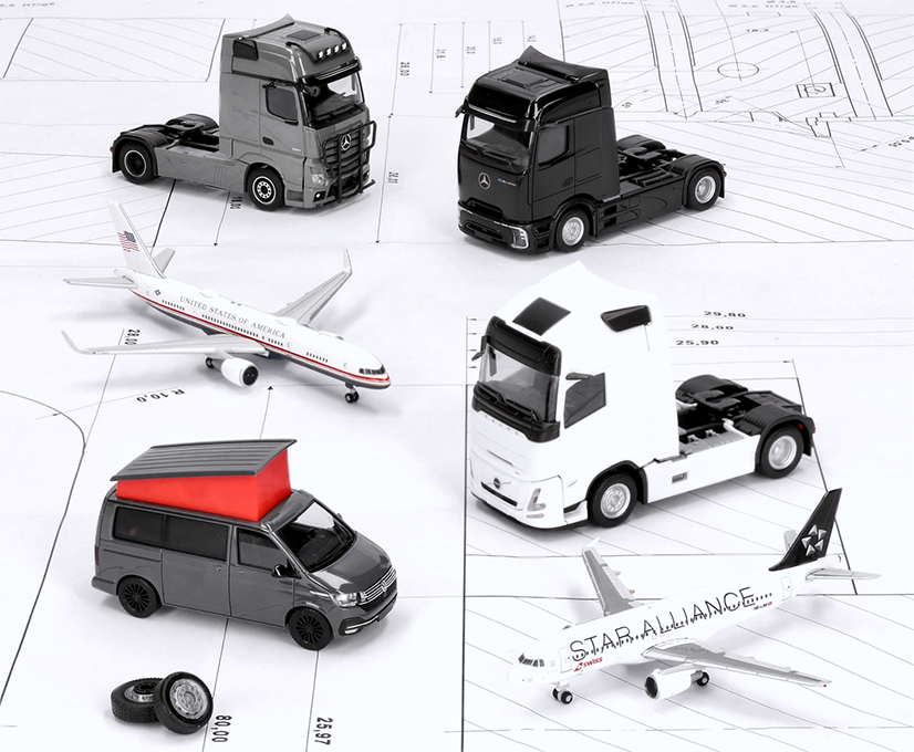 Selection from the Herpa September 2026 delivery: Miniature models are standing on a construction drawing.